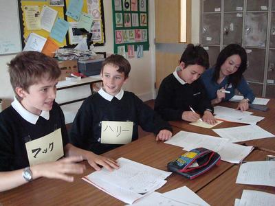 Year 7 students at Priory School trying Japanese with StepOutNet volunteer Asami Harada